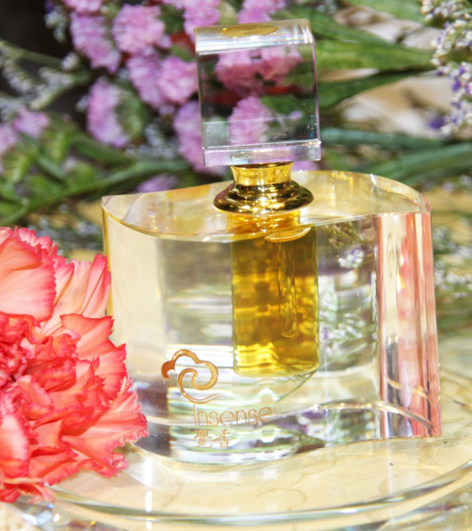 Insense agarwood essential oil presented among flowers